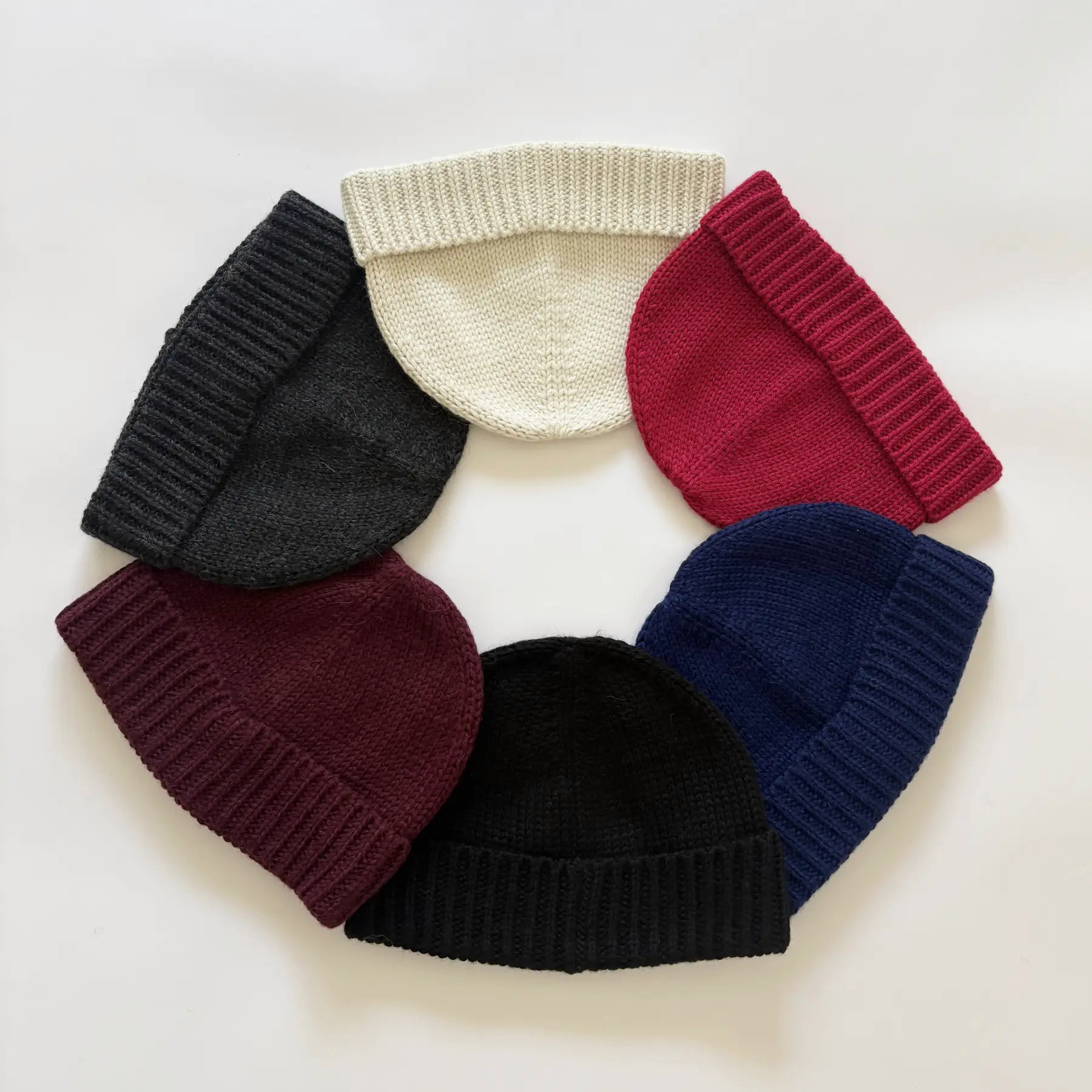 Close-up of a cream baby alpaca knitted beanie on a white background