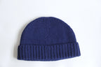A blue 100% baby alpaca beanie on a white background