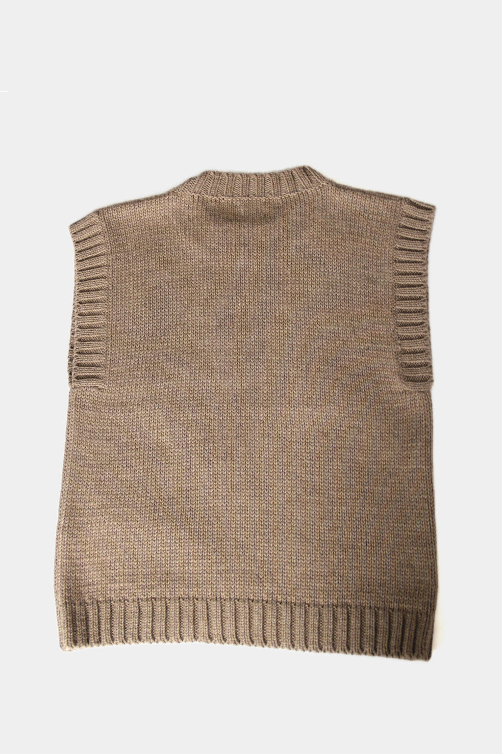 Beige baby alpaca sleeveless vest with ribbed crewneck on white background