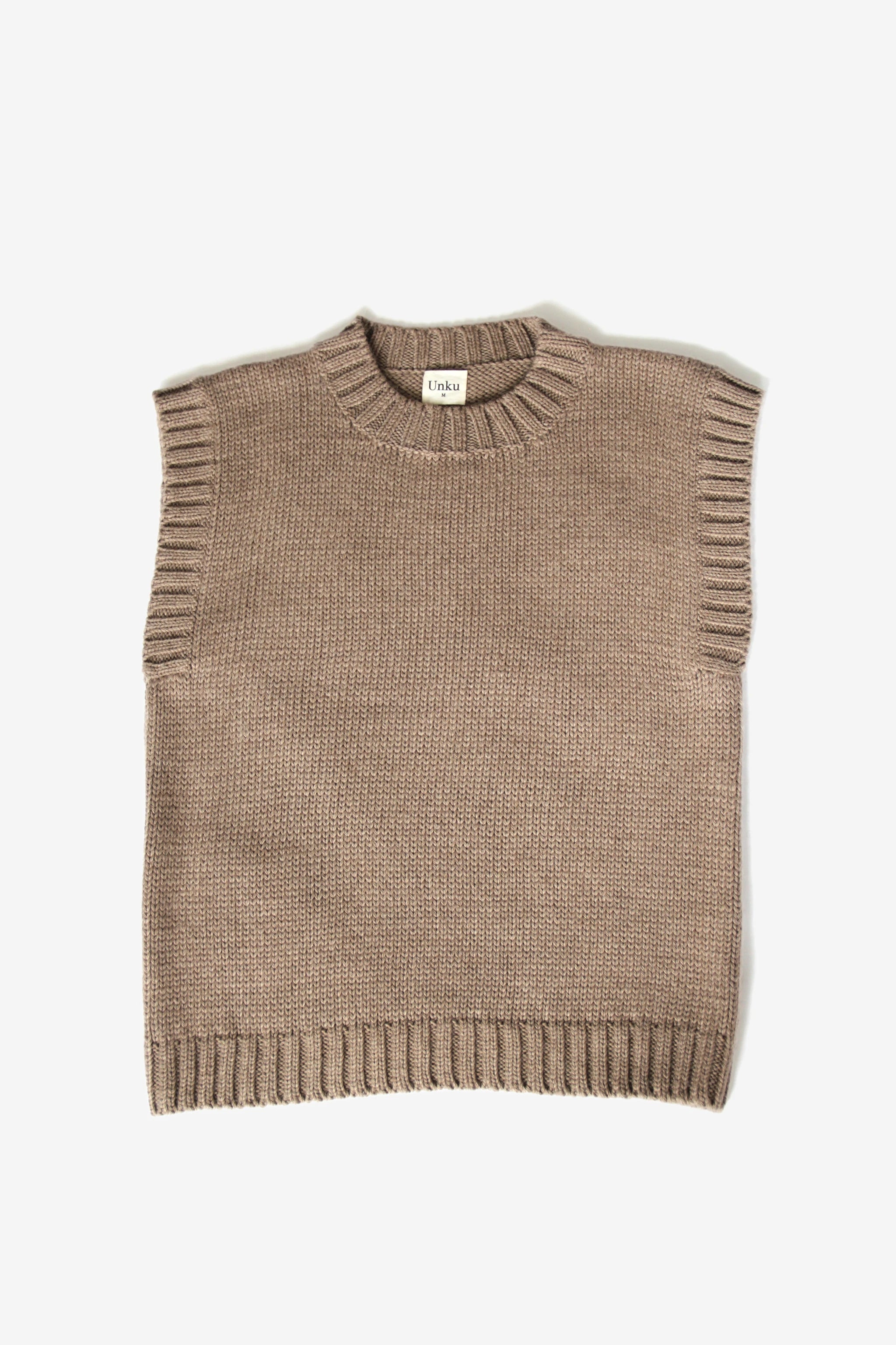 Beige baby alpaca sleeveless vest with ribbed crewneck on white background