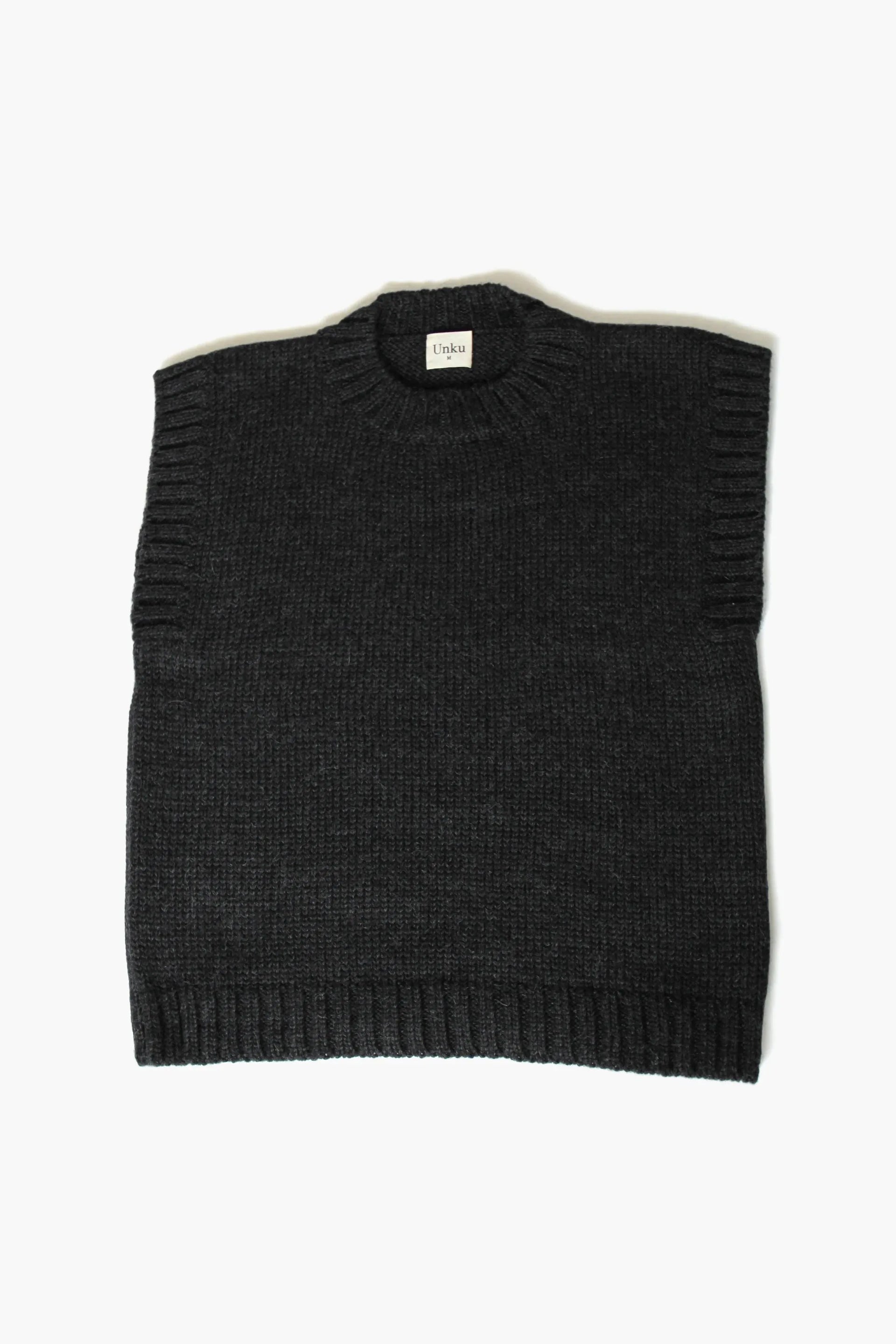 Charcoal baby alpaca sleeveless vest with ribbed crewneck on white background