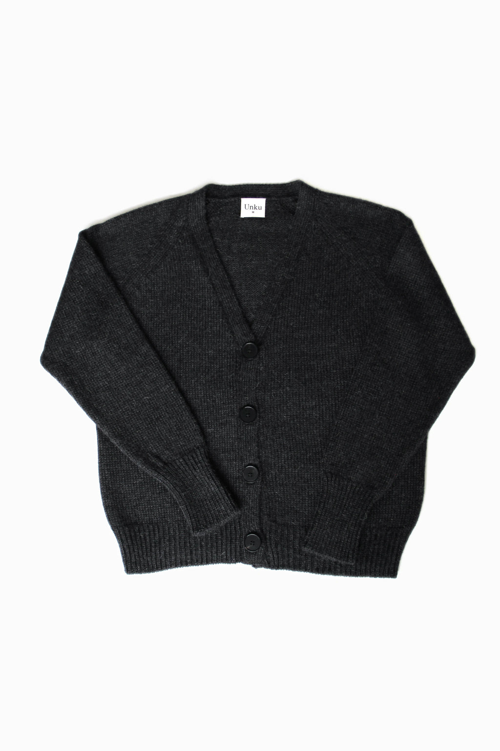 Dark gray 100% baby alpaca cardigan with black horn buttons on a white background