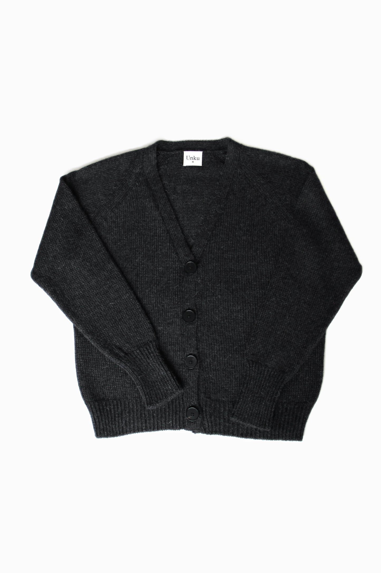 Dark gray 100% baby alpaca cardigan with black horn buttons on a white background